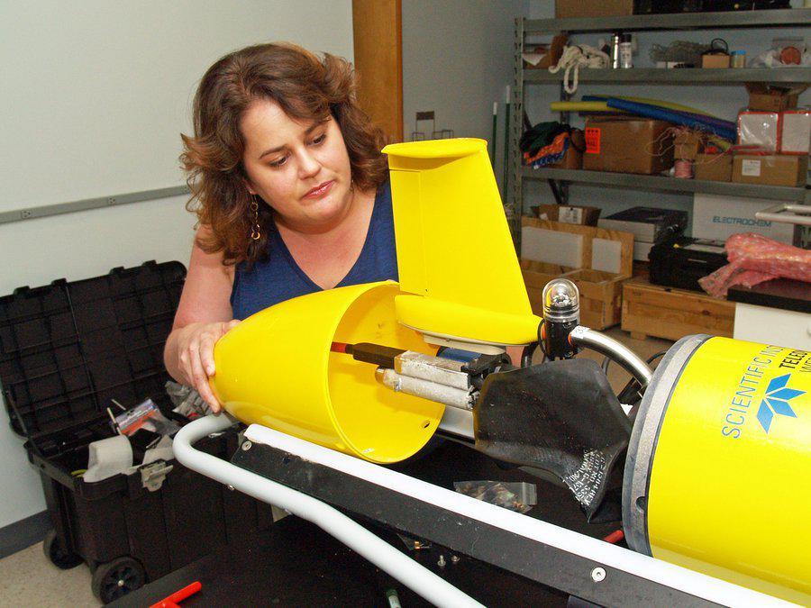 UGA Skidaway Institute researcher Catherine Edwards examines the tail assembly of a glider.