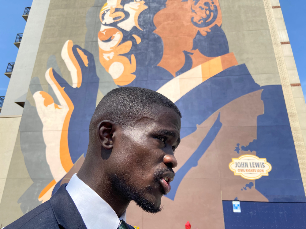 Rev. James Woodall, president of the Georgia NAACP, speaks in front of the John Lewis mural in Atlanta.