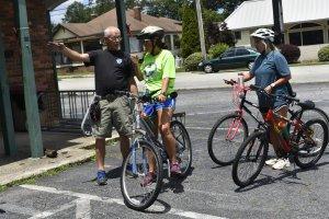 Allen Griffin of Perpetual Motion Bicycles in Carrollton gives directions gives directions to a couple of bikers who stopped by for a tune-up before their ride. 