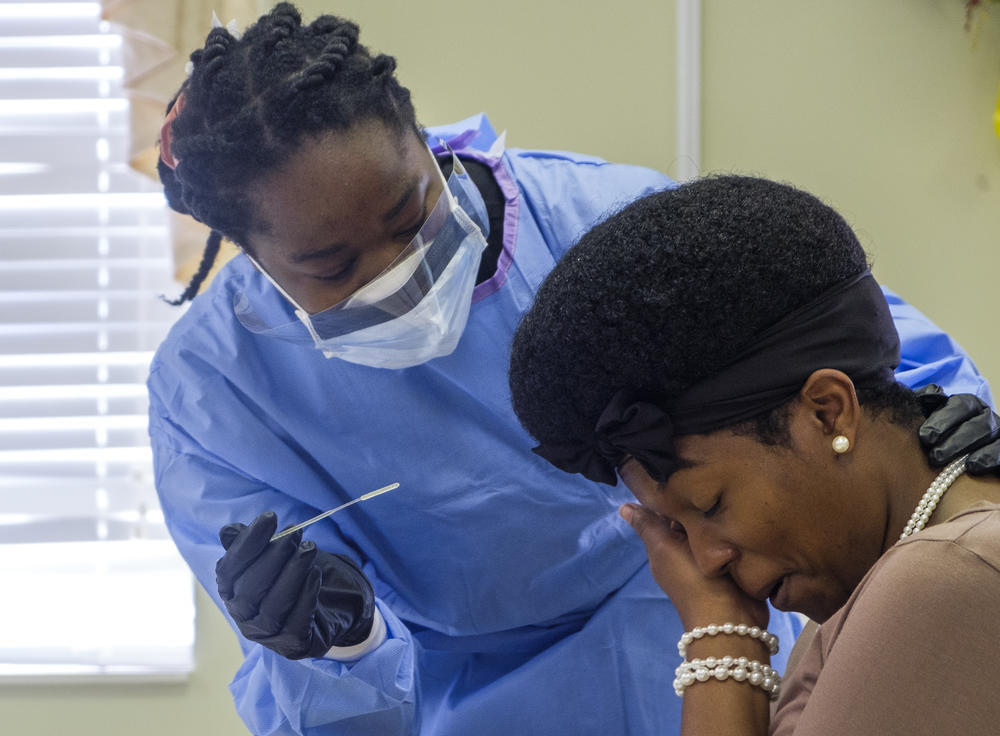 Precious Burnette takes a pause before the second of two nasal swabs during a coronavirus test in Macon.