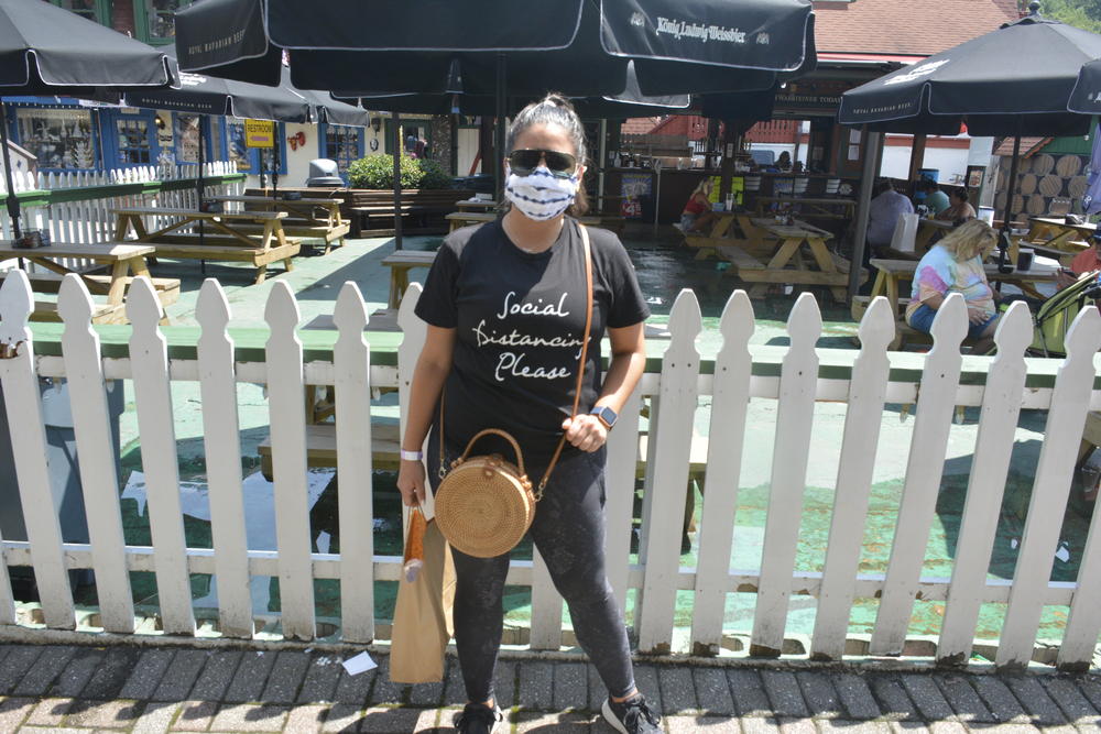 Fabiola Batiz wears a shirt that says "Social Distancing Please" in downtown Helen, GA.