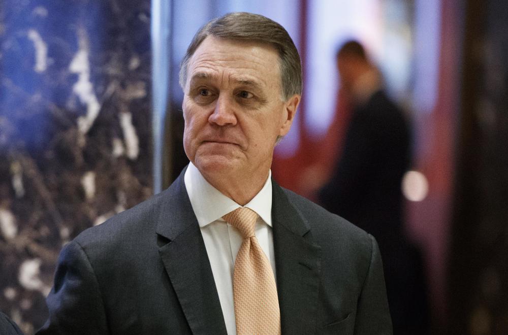 Sen. David Perdue, R-Ga., walks to the elevator for a meeting with President-elect Donald Trump at Trump Tower, in New York.