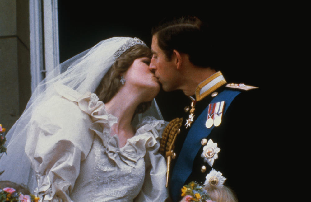 Princess Diana and Prince Charles kiss after their wedding.