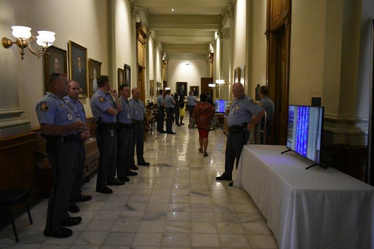 Georgia State Patrol officers monitor the tote board in June as state lawmakers approved legislation to create new protections for them. 