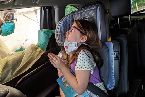 Kira Johnson, 9, gets a test for COVID-19.
