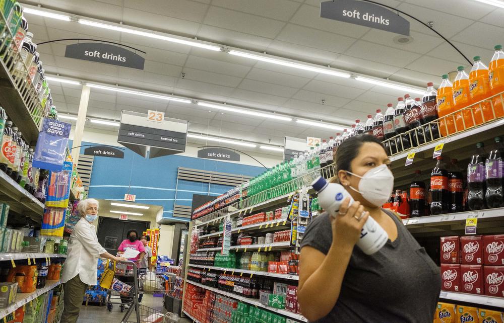 Shoppers with various takes on mask use in a grocery store in Macon on August 4, 2020. 