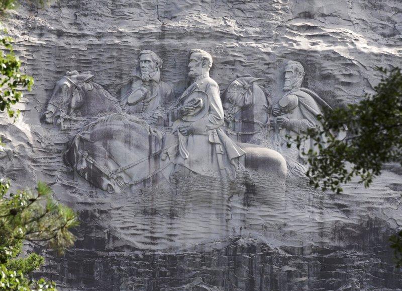 This June 23, 2015 file photo shows a carving depicting Confederate Civil War figures Stonewall Jackson, Robert E. Lee and Jefferson Davis, in Stone Mountain, Ga. The sculpture is America's largest Confederate memorial.