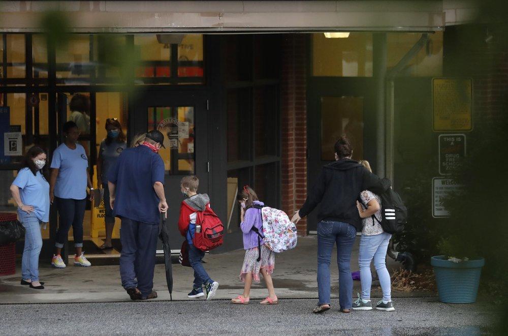 Students arrive to Dallas Elementary School for the first day of school amid the coronavirus outbreak on Monday, Aug. 3, 2020, in Dallas, Ga