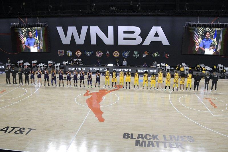 Members of the Phoenix Mercury, left, and Los Angeles Sparks stand for a moment of silence in honor of Breonna Taylor before a WNBA basketball game, Saturday, July 25, 2020, in Ellenton, Fla.