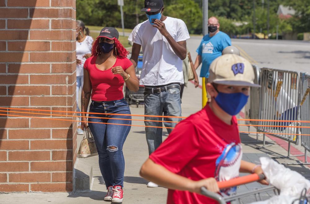 Shoppers at the entrance to the Walmart store on Zebulon Road in Macon recently. 