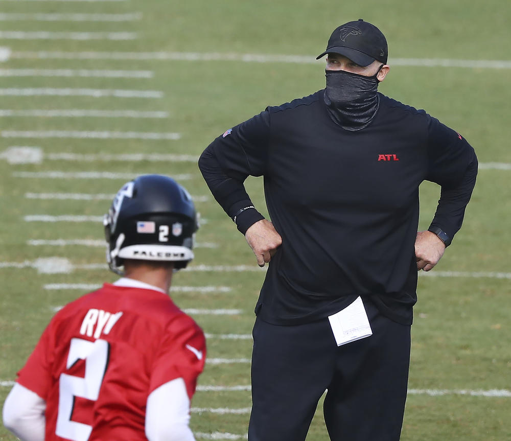 Atlanta Falcons head coach Dan Quinn watches over NFL football training camp on Wednesday, Aug. 19, 2020, in Flowery Branch, Ga. 