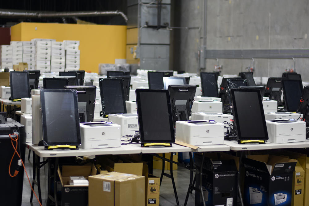 Rows of ballot-marking devices are tested at a state warehouse in Cobb County.