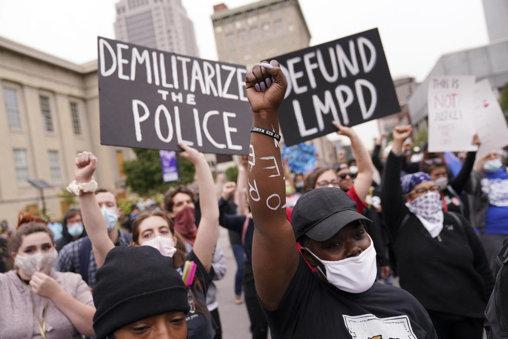 Protesters speak, Wednesday, Sept. 23, 2020, in Louisville, Ky. A grand jury has indicted one officer on criminal charges six months after Breonna Taylor was fatally shot by police in Kentucky. The jury presented its decision against fired officer Brett Hankison Wednesday to a judge in Louisville, where the shooting took place.