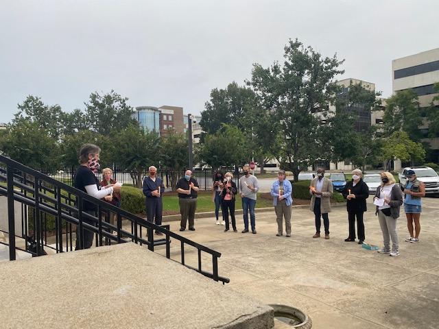 People stand in front of the federal courthouse in Macon.