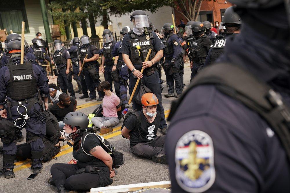 Police detain protesters, Wednesday, Sept. 23, 2020, in Louisville, Ky. 