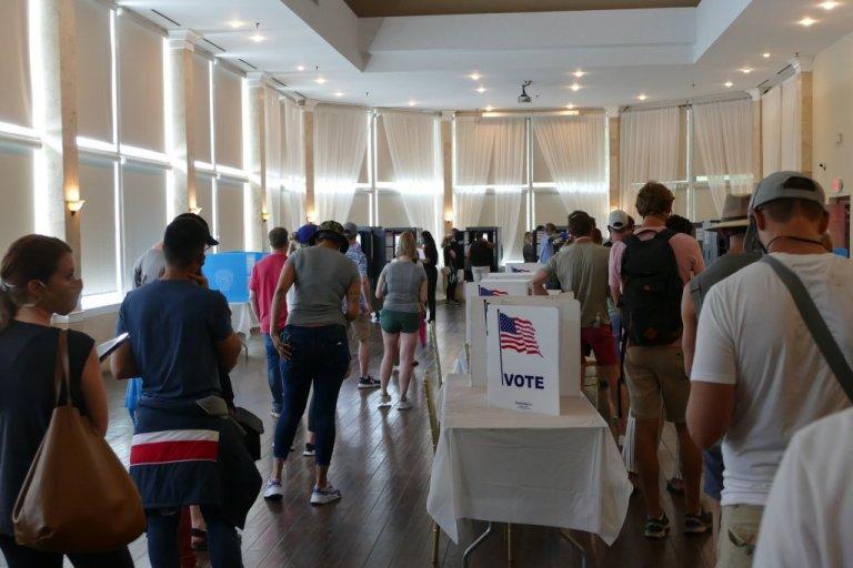 Voters line up at Park Tavern voting precinct for election in June 2020.