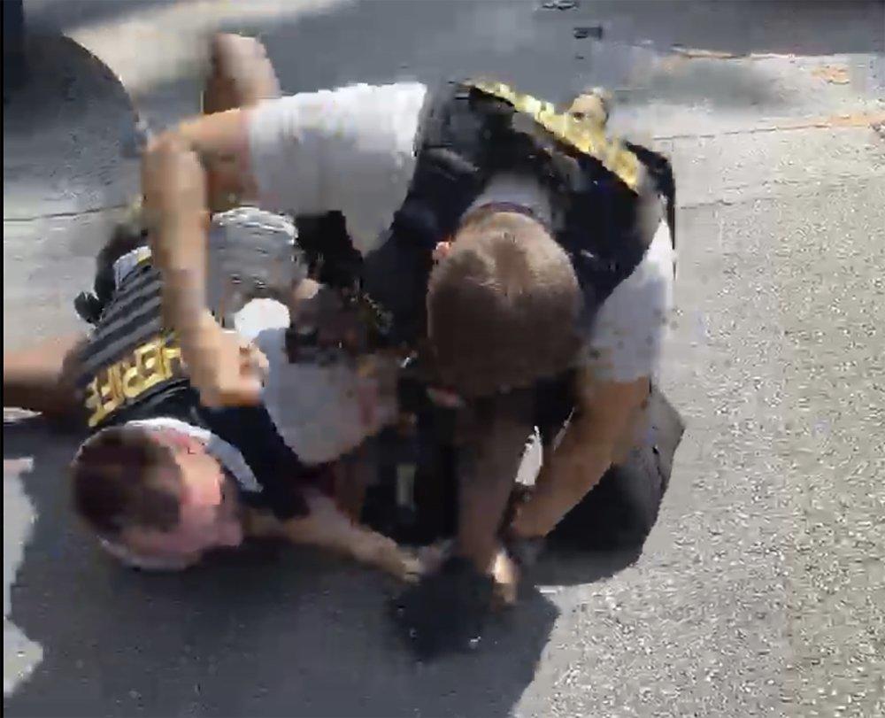 In this screen grab from video shot by Juanita Davis and provided by The Cochran Firm, a Clayton County, Ga., sheriff’s deputy holds down Roderick Walker while another deputy punches him while on the ground, Friday, Sept. 11, 2020, following a traffic stop.