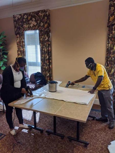 Workers at a Rollins-owned hospice making gowns amid the pandemic.