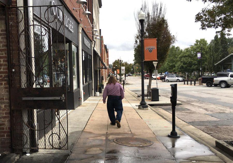 Man walks down Poplar Street in Macon