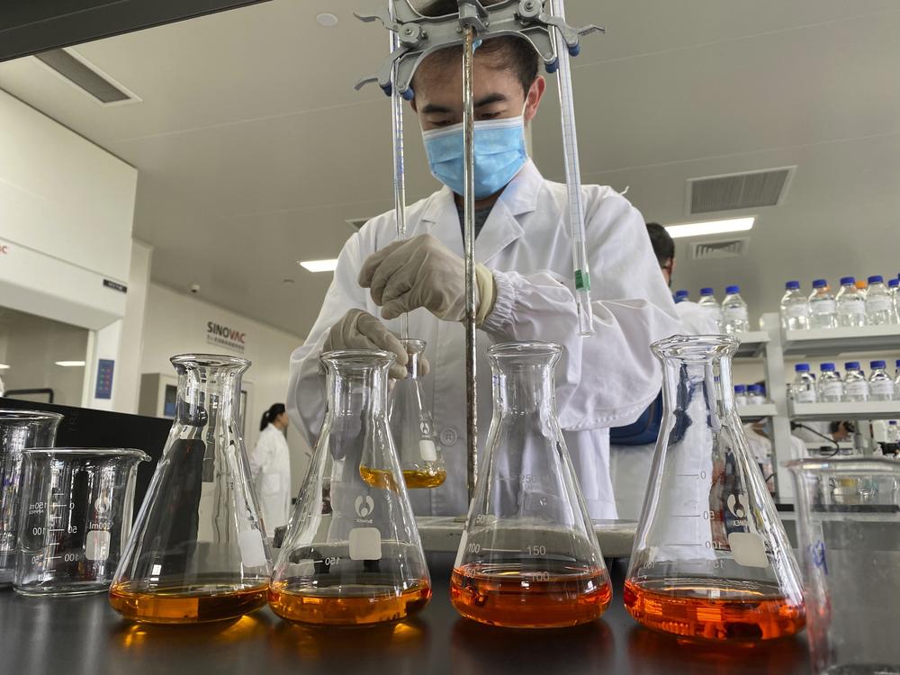 A worker works inside a lab at the SinoVac vaccine factory in Beijing on Thursday, Sept. 24, 2020. SinoVac, one of China's pharmaceutical companies behind a leading COVID-19 vaccine candidate says its vaccine will be ready by early 2021 for distribution worldwide, including the U.S. 