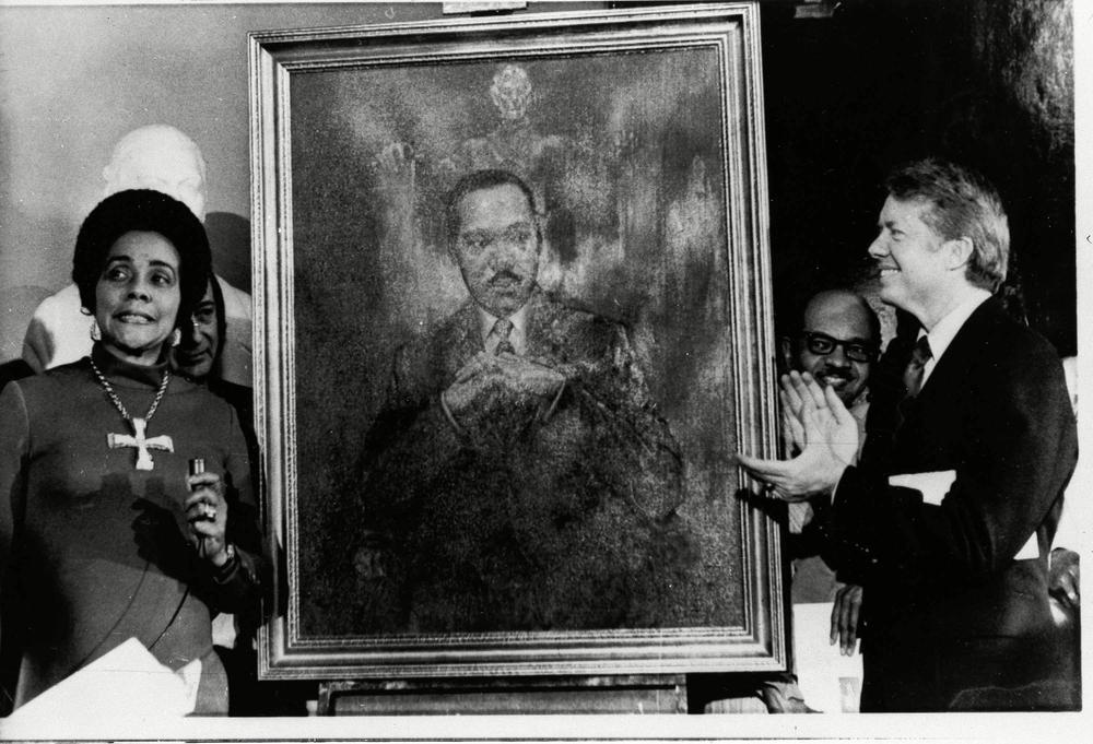 Coretta Scott King, widow of slain civil rights leader Dr. Martin Luther King, Jr., speaks at an unveiling of a portrait of Dr. King by artist George Mandus, Feb. 18, 1974, and dedicated by Gov. Jimmy Carter. It is the first portrait of an African American to be represented in the state's official portrait gallery. 