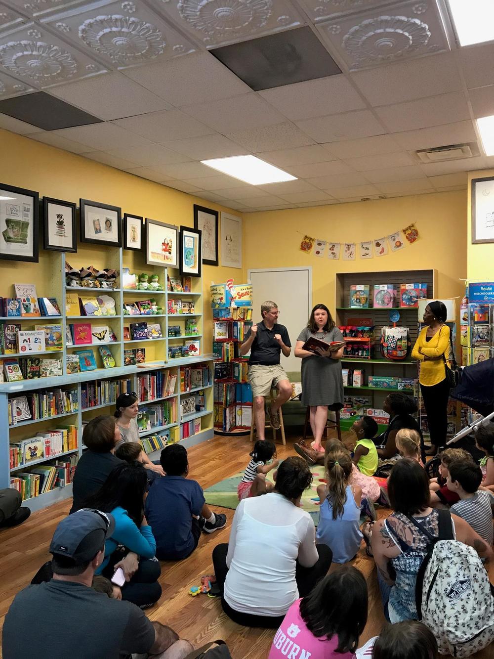 Jimmy Peterson interprets a book reading in front of children.