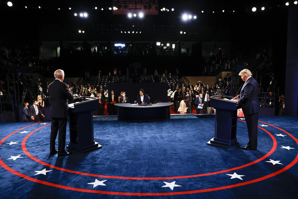 Joe Biden and Donald Trump stand on the debate stage.