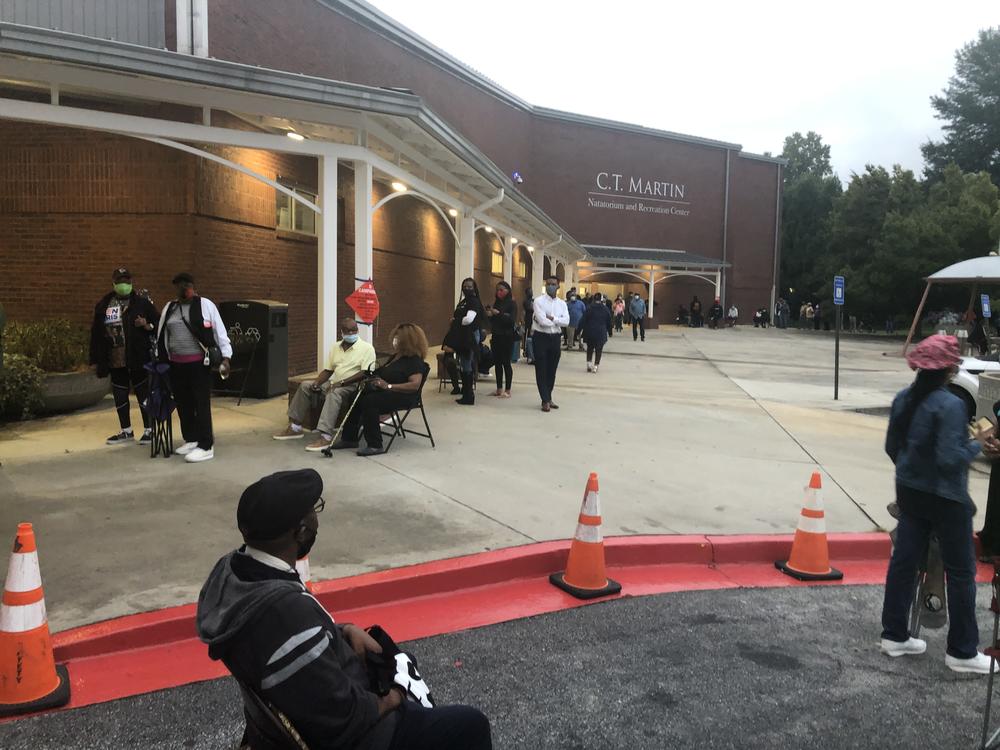 More than 200 voters wait in line at the C.T. Martin Natatorium in Fulton County before polls open for early voting.