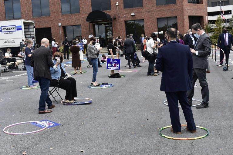 Georgia Democrats stand in socially distanced hula hoops in a Decatur parking lot a they await former Second Lady Jill Biden. 