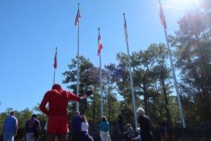 Raphael J. Holland (in red), who lives in Atlanta, participates in a “prayer for our park” event at Stone Mountain Park. Holland said he believes the Confederate flags should be removed from the park.