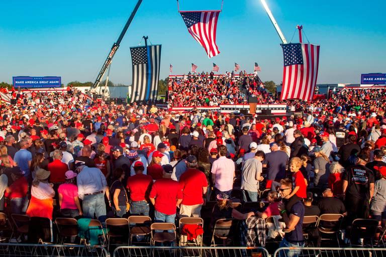 Attendants of President Donald Trump’s Make America Great Again campaign rally cheer before his arrival at the Middle Georgia Regional Airport in Macon.