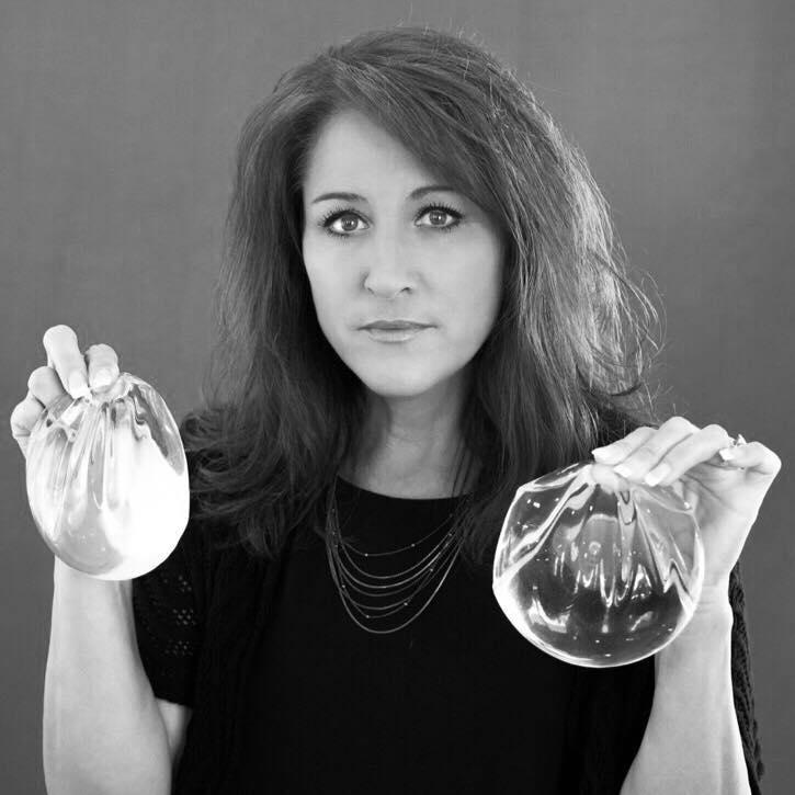 A woman holds breast implants