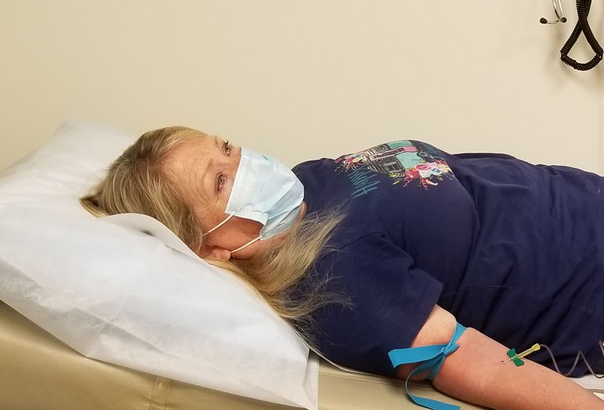 Shelly Groves receives a COVID-19 vaccine dose as part of the Moderna clinical trial at Emory University in August 2020.
