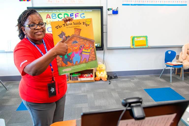 Veterans Elementary kindergarten teacher Christine Jones gives a thumbs up to her students watching on a webcam after reading “The Three Little Pigs” Tuesday during the first day of virtual learning for Bibb County Schools. 