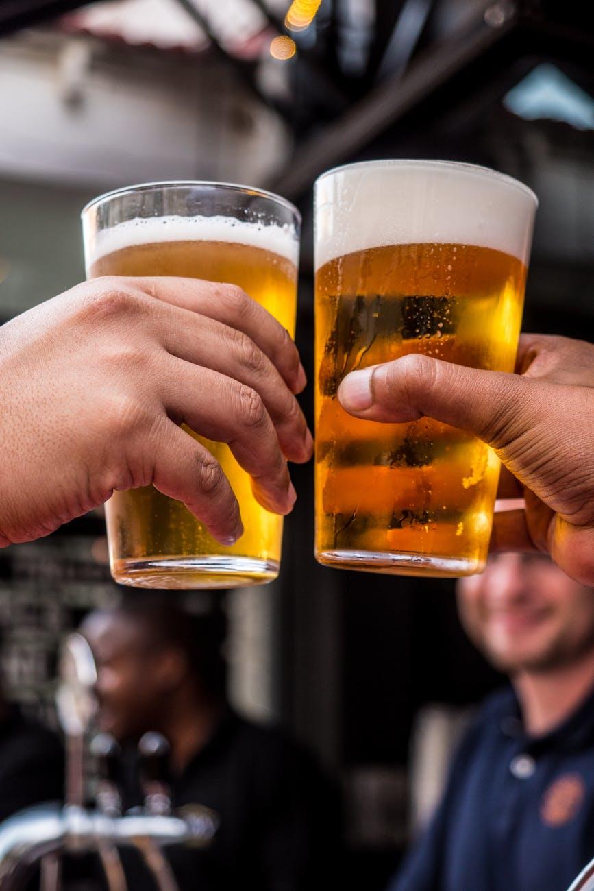 People holding glasses of beer