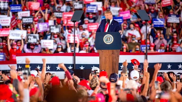 President Donald Trump arrives to his Make America Great Again campaign rally cheer before his arrival at the Middle Georgia Regional Airport in Macon.