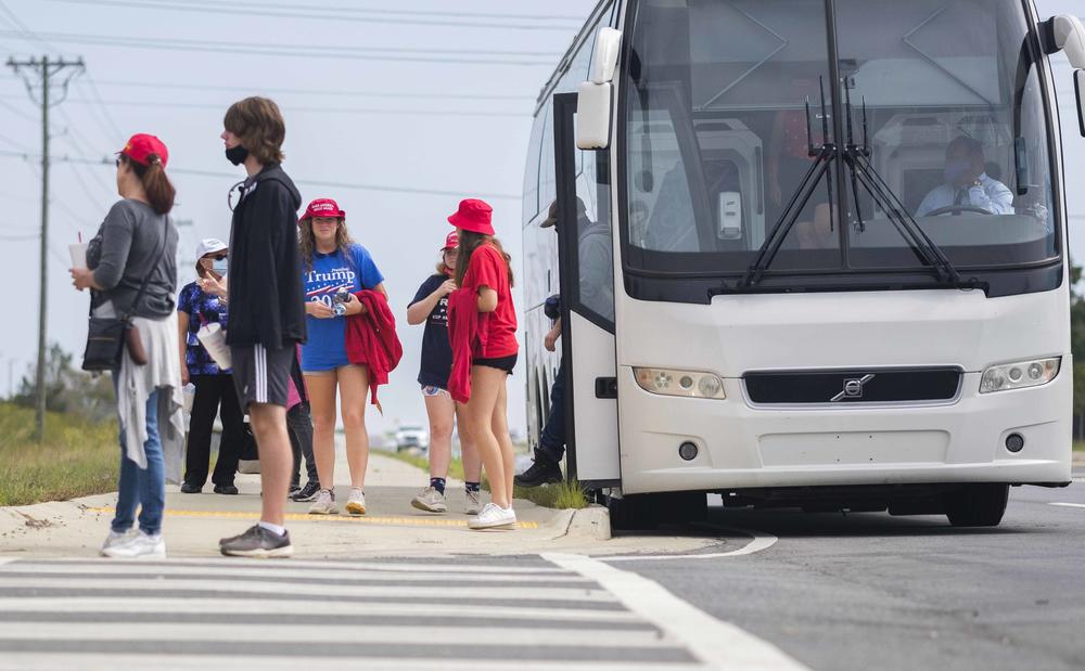 Trump rally goers were carried from their cars to the Middle Georgia Regional Airport Friday 50 at a time in travel coaches. 