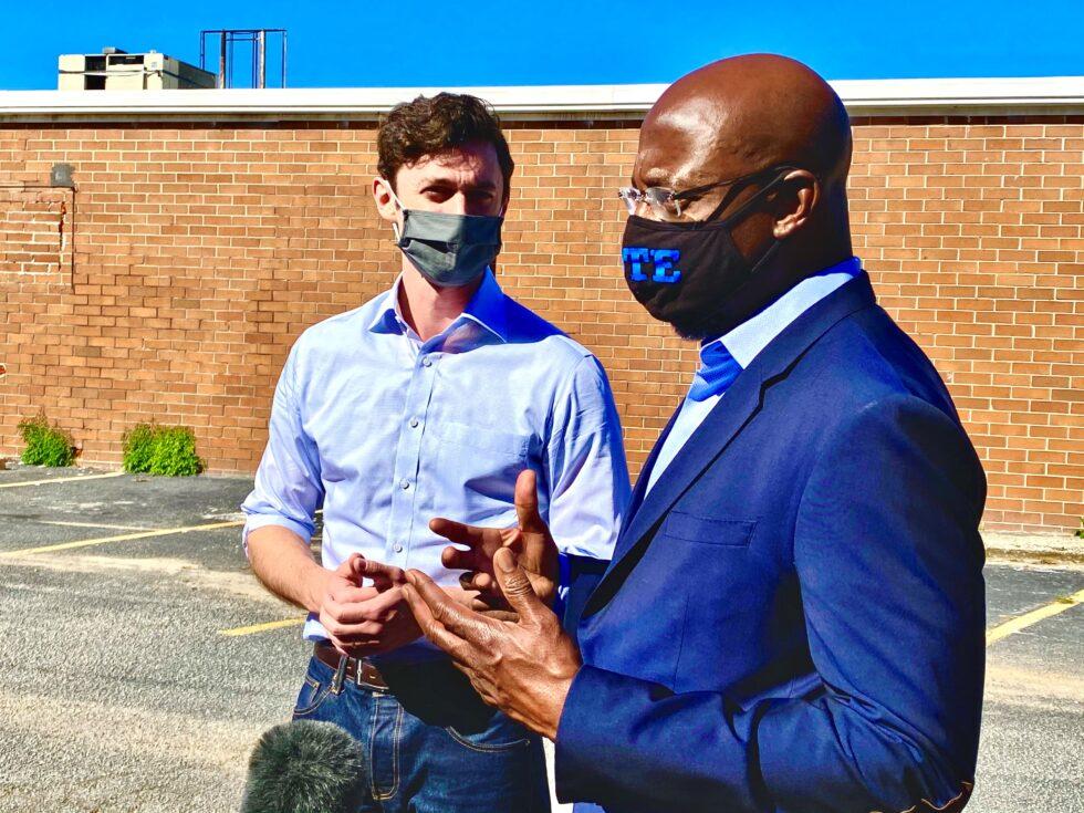 Rev. Raphael Warnock (right) rallies with Jon Ossoff (left) at a joint campaign stop in DeKalb County in Georgia’s U.S. Senate races on Oct. 3, 2020.