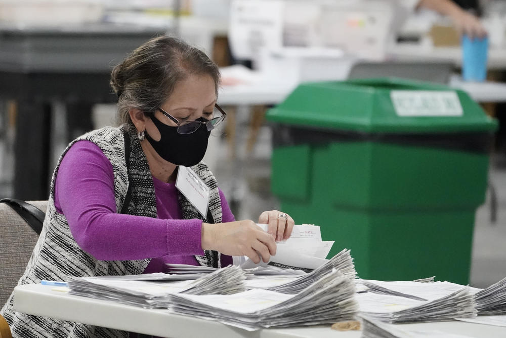 Officials work on ballots at the Gwinnett County Voter Registration and Elections Headquarters, Friday, Nov. 6, 2020, in Lawrenceville.