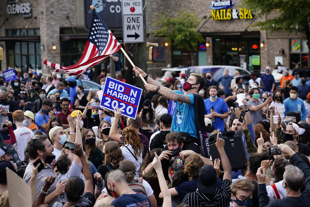 Supporters celebrate the victory of President-elect Joe Biden, Saturday, Nov. 7, 2020, in Atlanta.