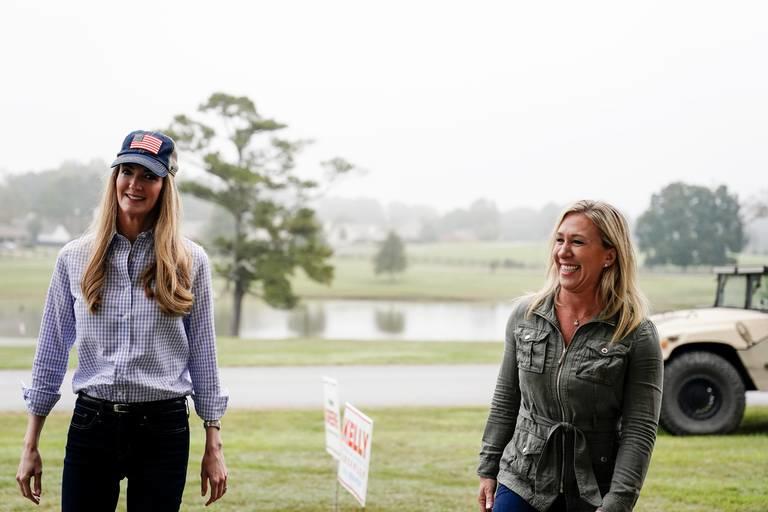 Sen. Kelly Loeffler, R-Ga., left, and Republican congressional candidate Marjorie Taylor Greene, right, arrive a news conference on Thursday, Oct. 15, 2020, in Dallas, Ga. 
