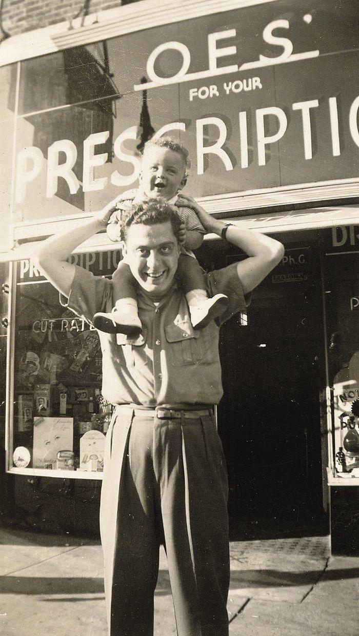 Arthur Blank’s brother, Michael, and his father, Max, stand outside the OES Pharmacy family business, in 1940. Max died when Arthur was 15, leaving his mother to grow what became a multi-million-dollar business.   Photo courtesy of AMBSE Creative.