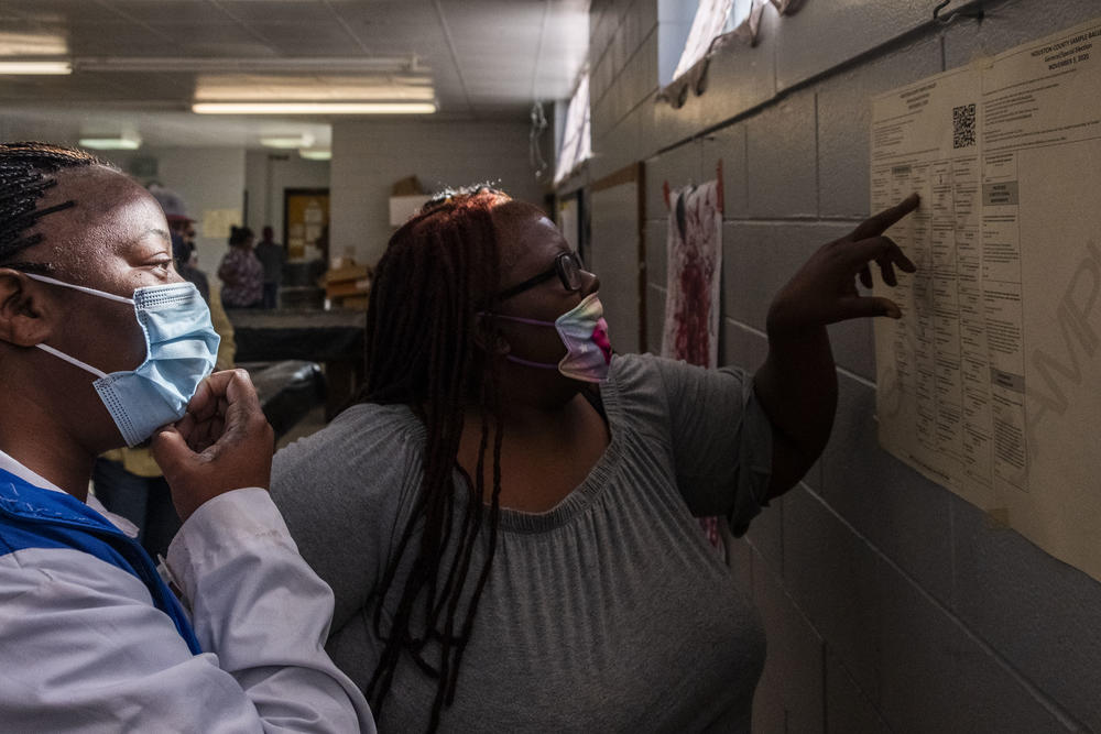 Two women examine a sample ballot at a polling location in Warner Robins, Georgia.