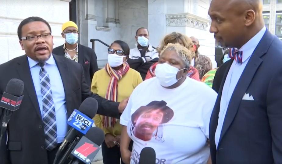 Betty Lewis, Julian Lewis's widow, stands with lawyers Francys Johnson (left) and Mawuli Davis while announcing their intent to sue the state of Georgia.