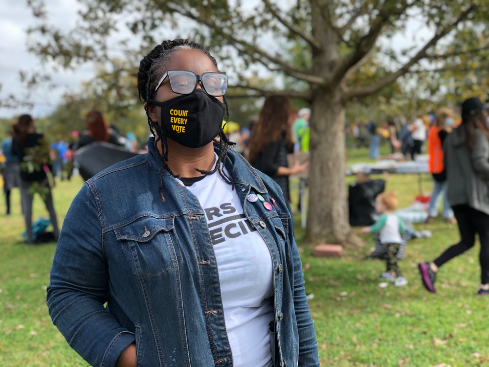 Nsé Ufot wears a face mask that says "count every vote."