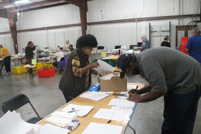TJ Burrison signs in to observe the count for Chatham County Republican Party. Burrison, who owns an appliance repair shop, worked Saturday at the annex.