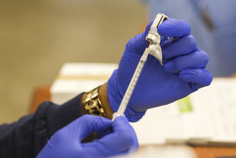A nurse at Phoebe Putney Memorial Hospital in Albany fills a syringe with the Pfizer coronavirus vaccine Thursday. 
