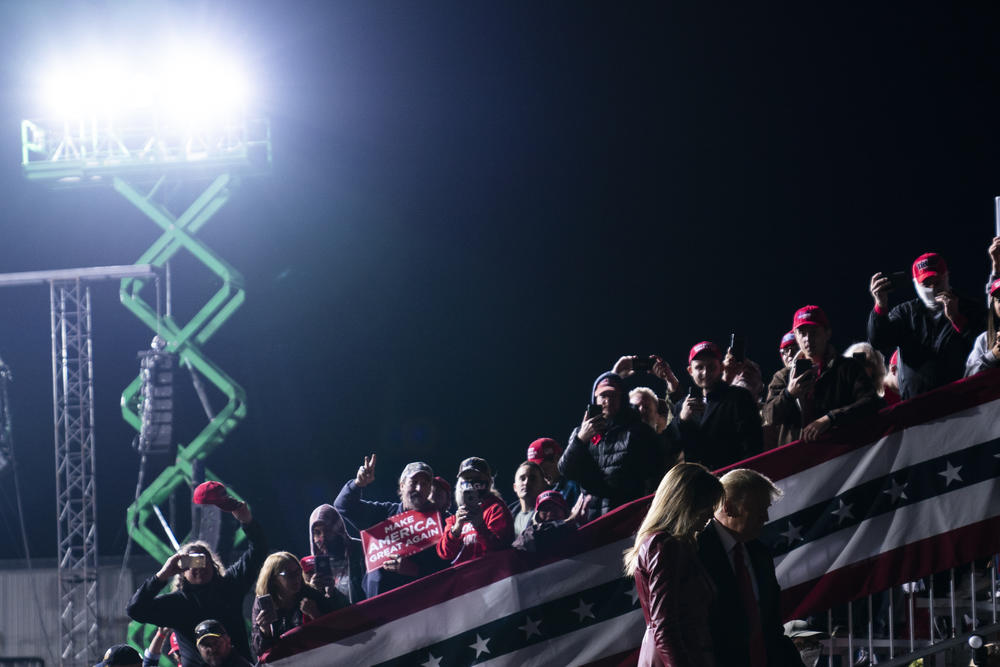 Donald and Melania Trump walk under bright arena lights during his rally in Valdosta over the weekend.