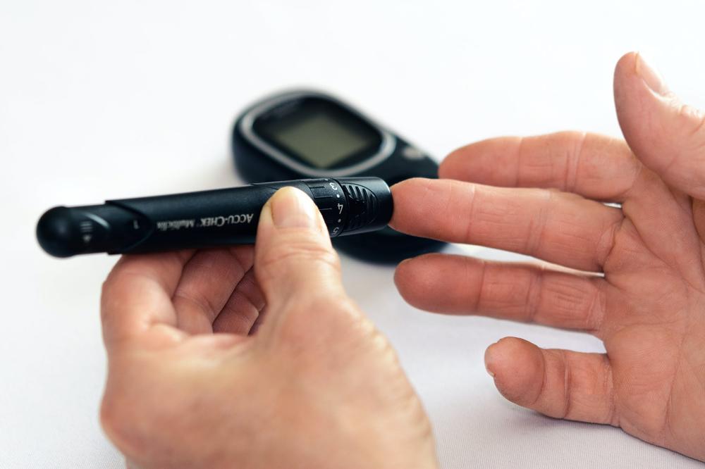 Person testing blood sugar