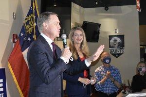 Sens. Kelly Loeffler and David Perdue share the stage at a campaign event in Forsyth County in November.
